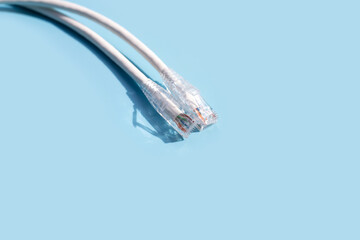LAN network connection ethernet white cables on blue background.