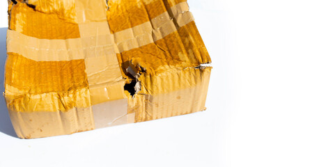 Damaged cardboard box with hole, Broken and wet product packaging