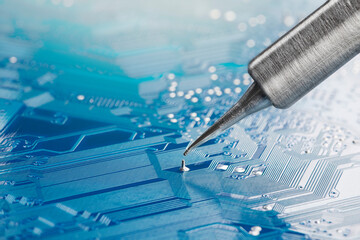 soldering iron solders the electronic components onto the PCB. Electronics repair and digital technology.