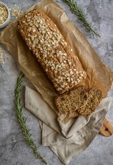 flat lay oat bread with rosemary on grey background