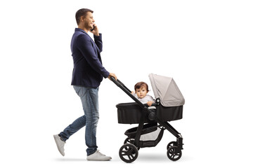 Full length profile shot of a father pushing a baby stroller and making a phone call