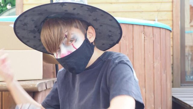 Halloween boy in carnival costume, face mask