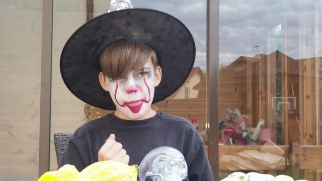 boy scull, teenager wearing scary jocker makeup