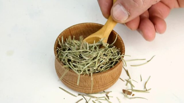 Chef taking spices dry rosemary.