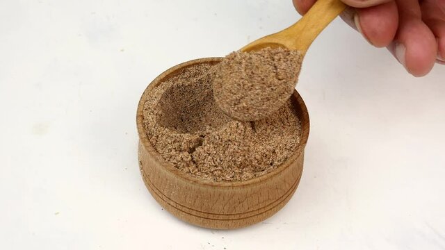 Chef taking chopped dry nutmeg powder spices.
