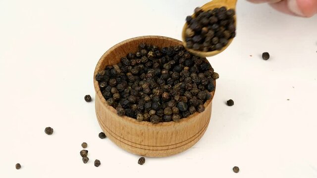 Chef taking dry spices black peppercorns and herbs