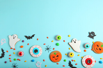 Halloween sweets on colored background close up top view with place for text
