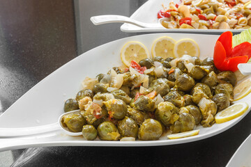 Boiled Brussels sprouts are in a large plate.