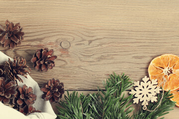 Zero waste and eco friendly christmas concept. Natural decorations and branches of Christmas tree on the wooden table, top view, flat lay, copy space