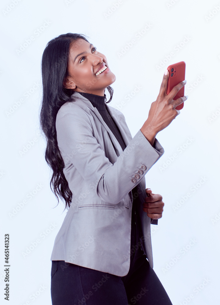 Wall mural Smiling, successful, black, confident woman with her phone posing for the camera