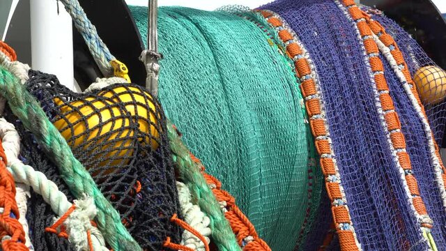 Removing a trawl on a fishing vessel. Close-up. The fishing net is wound on a drum.