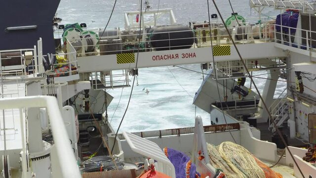 Fishing vessel feed. Rear taiwan sways on the waves to catch the trawl.