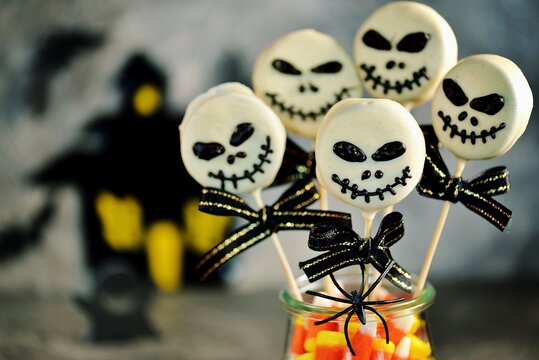 Homemade Halloween cake pops skeletons with white chocolate. Halloween sweets. 