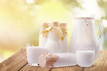 Glass and jug of fresh tasty milk, dairy products
