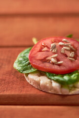 Rice cakes with Spinach and tomatoes on top. Healthy food.