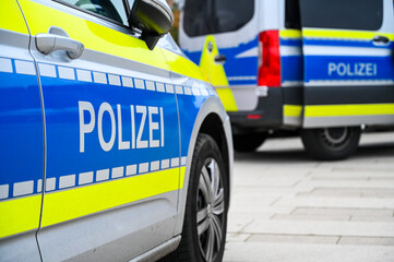 German police cars on the street. Side view of a police car with the lettering "Polizei".  Police patrol car parked on the street in Germany. © Ajdin Kamber