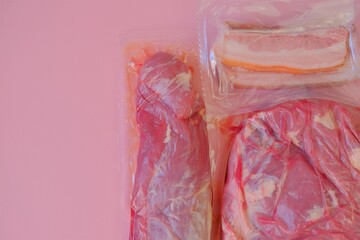  Pork meat.Fresh pork pieces close-up. Protein foods. meat texture.Vacuum packed meat on a pink background.Meat products.