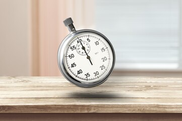 Classic metallic chrome mechanical analog stopwatch on the desk