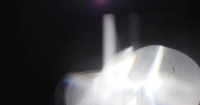 Footage of White Lights Leaks Overlay on Black Background. Concept the Motion of Bokeh. Natural Lighting Lamp Rays Bokeh Effect. Background Compositing. 4K Resolution. Prism Lights.