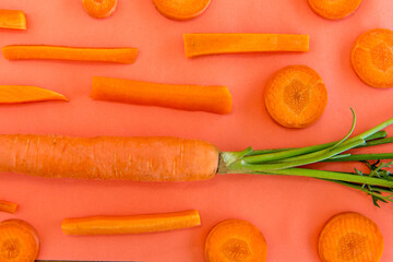 Carrot  on a table with an orange background.