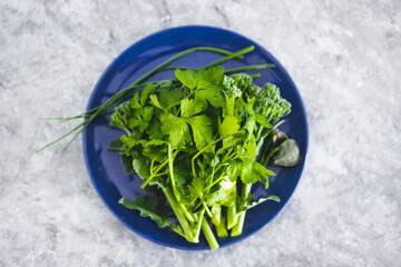 freshly picked mixed greens including Italian parsley broccolini and chives, healthy plant-based food