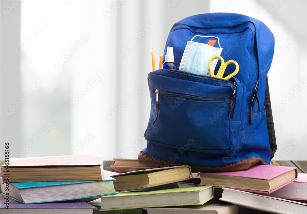 Wall mural Classic backpack with different school stationery on the desk