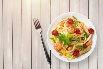Pasta with cherry tomatoes, cheese and basil on a light plate