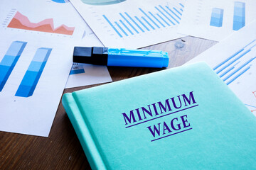  MINIMUM WAGE sign on the book cover.