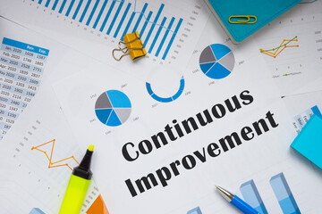 Financial concept about Continuous Improvement with inscription on the piece of paper.