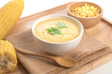 Corn soup in white bowl on wooden background. Fresh corn healthy food.
