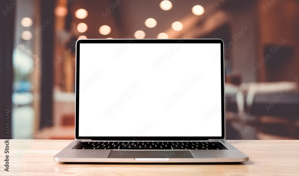 Fototapete laptop blank screen on wood table with blurred coffee shop cafe interior background and lighting bok