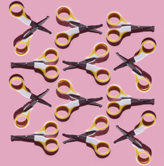 Pattern of Safety nail baby scissors on pink background. Kid's body care and hygiene concept