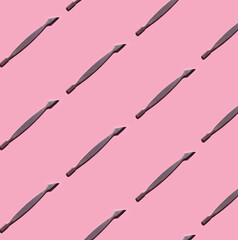 Modern Pattern of Professional tools for manicure - Cuticle pusher on pink background. Basic nail...
