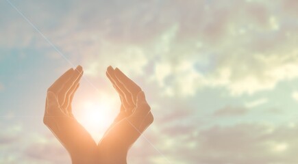 Fototapeta na wymiar Human hands holding the sun at dawn. Freedom and spirituality concept.