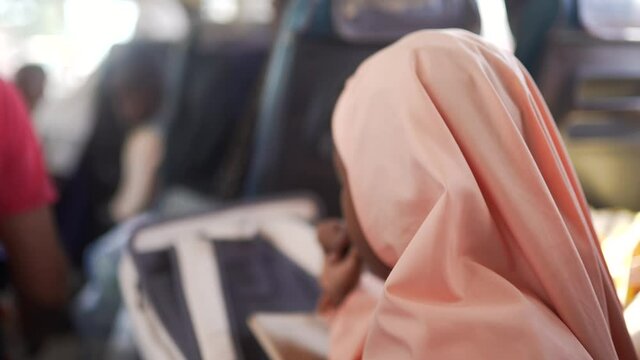 African Islamic Black Girl Wearing A Headscarf, Hijab, Burqa Going To School In A Bus. Education In Poor Islamic Countries. Africa 4K.