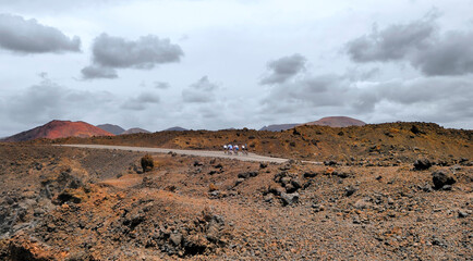 cyclists on the road in volcanic desert