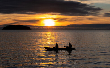 Kayakers at sunset in the sea at Koh Chang island in the Gulf of Thailand