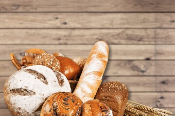 Fresh loaves of bread with wheat and gluten on a table