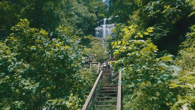Epic footage of a footbridge leading up to Amicalola Falls, the largest waterfall in all of Georgia &ndash; towering over the area at 729 feet tall