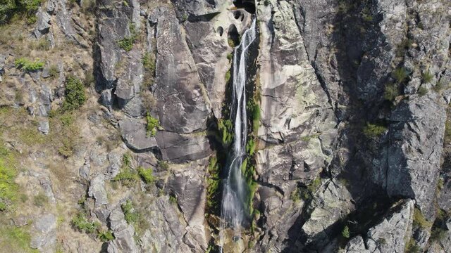 Aerial High stream water flowing down stone walls, Serra da Freita Geopark
