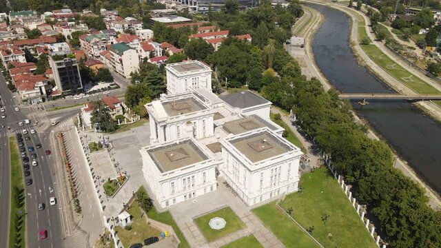 Government of Republic of Macedonia, Skopje. Aerial View, Building, Vardar River and Traffic on Ilinden Boulevard on Sunny Day, Orbiting Drone Shot