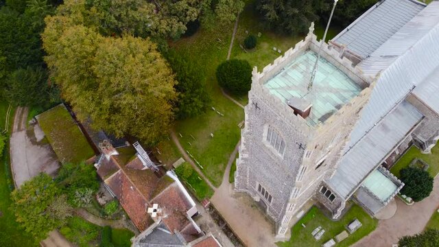 Flying over St Michael's church tower in Framlingham, England - aerial top down drone shot