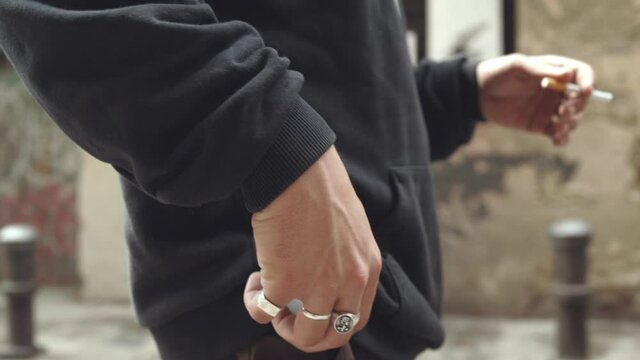 Long haired caucasian man lights up a cigerette, cinematic, slow motion