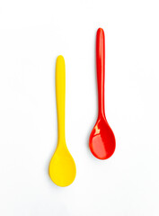 An image vertical two artificial spoon colorfuls as blue and yellow on white background with clipping path for use.