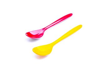 An image vertical two artificial spoon colorfuls as blue and yellow on white background with clipping path for use.