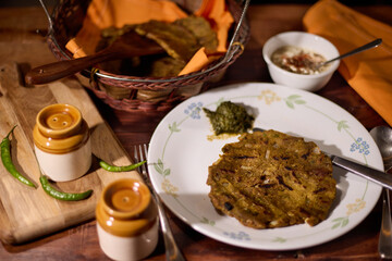 Traditional Indian healthy breakfast known by the name Thalipeeth a savoury multi-grain flatbread popular in Western India, particularly Maharashtra. The flour for thalipeeth, called bhajanee, is p
