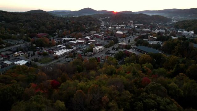 sunrise aerial push into town of boone nc, north carolina in fall at sunrise