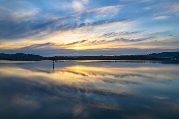 Sunrise and cloud reflections waterscape