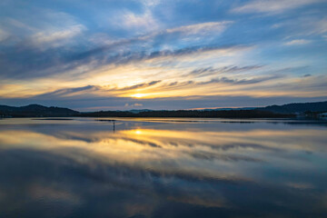 Sunrise and cloud reflections waterscape