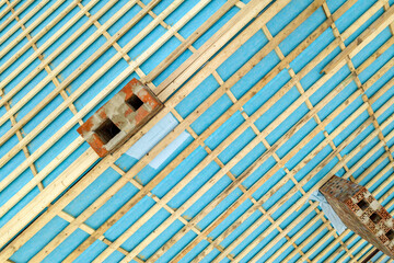 Top down detail of a wooden roof frame on a house under construction.